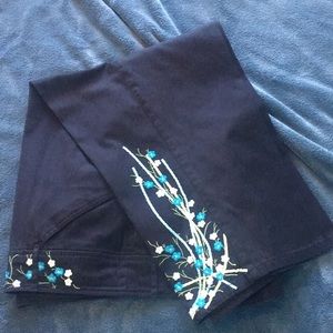 Venezia black capris with flower embroidery.